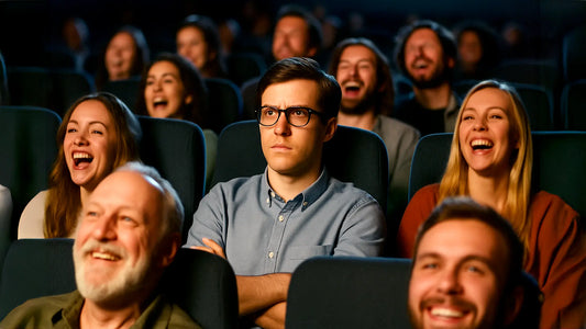 Crowd laughing in a movie theater while one introverted viewer sits serious, highlighting the loner stereotype.