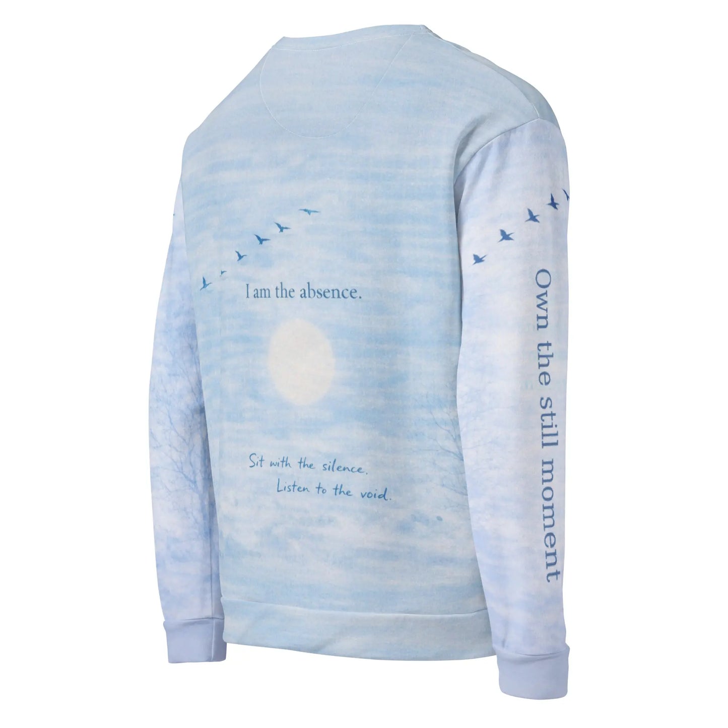 Angled back view of cloud print quote sweatshirt showing “I am the absence” with birds in flight and “Own the still moment” printed on the sleeve