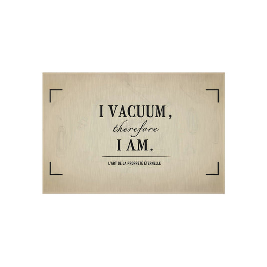Neutral beige 24 × 36 inch rug with black typography reading “I Vacuum Therefore I Am”