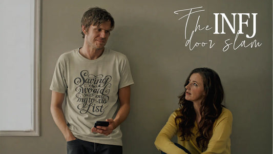 A man in a beige t-shirt with a decorative quote design stands holding a phone, while a woman in a yellow sweater sits on the floor looking up at him. Text on the image reads "The INFJ door slam."