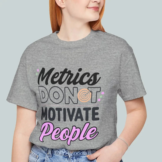 Model wearing grey Metrics Do Not Motivate People leadership tee with front statement graphic