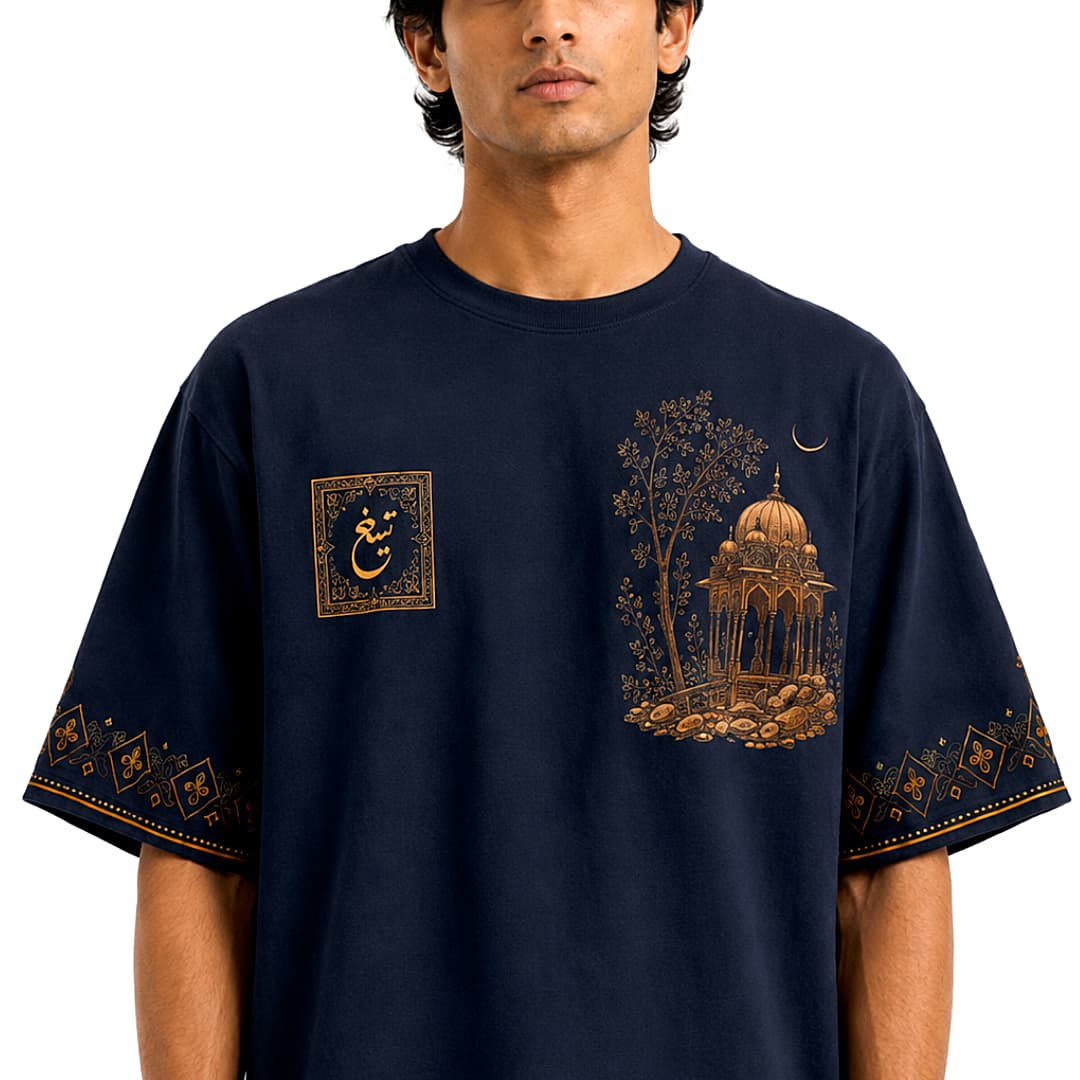 Male model wearing navy Mughal art oversized T-shirt with pavilion graphic and Urdu emblem