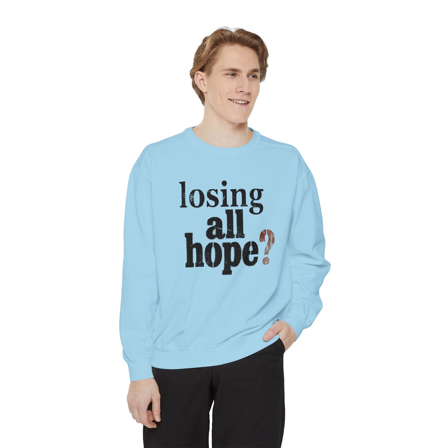 Person wearing a light blue sweatshirt with text on a white background