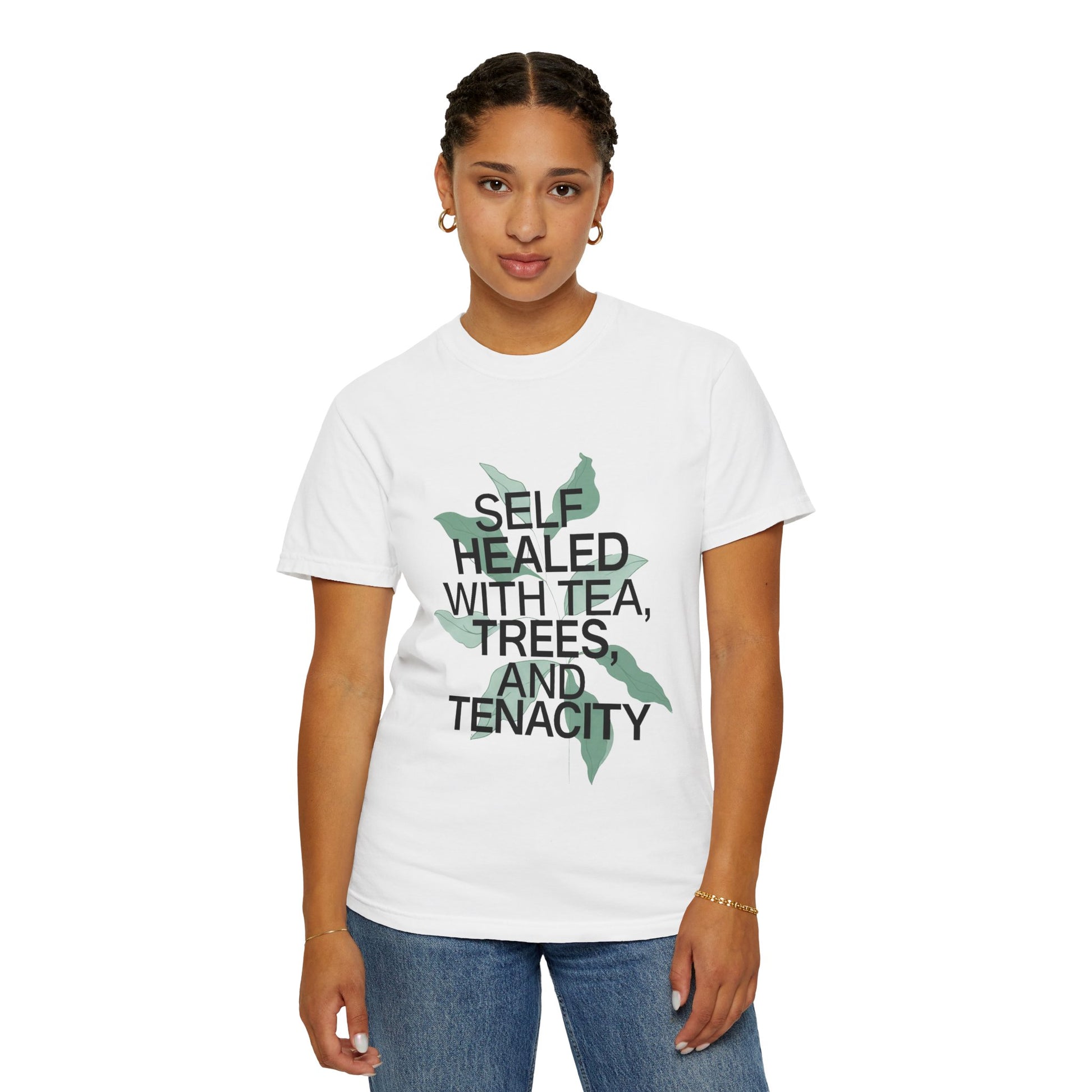 Person wearing a white t-shirt with text and a leaf graphic on a white background
