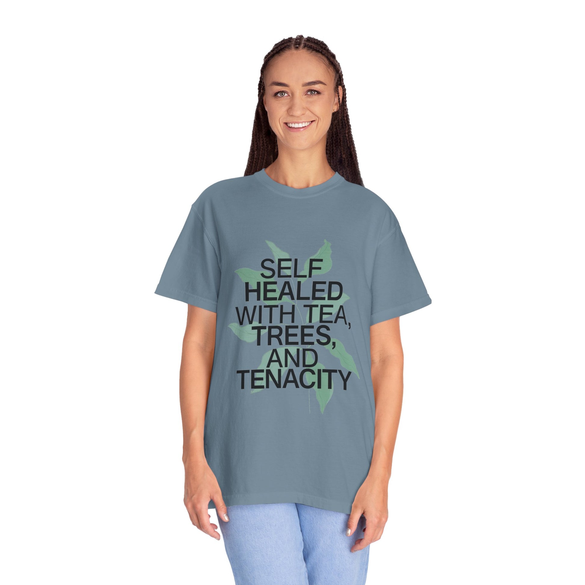 Person wearing a blue t-shirt with text and a tree graphic on a white background