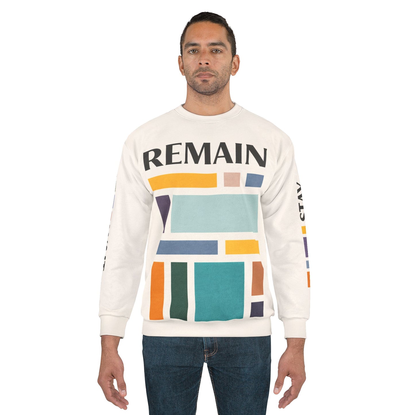 Male model wearing abstract color block sweatshirt with muted teal, mustard, rust and navy geometric print and the word REMAIN across the chest