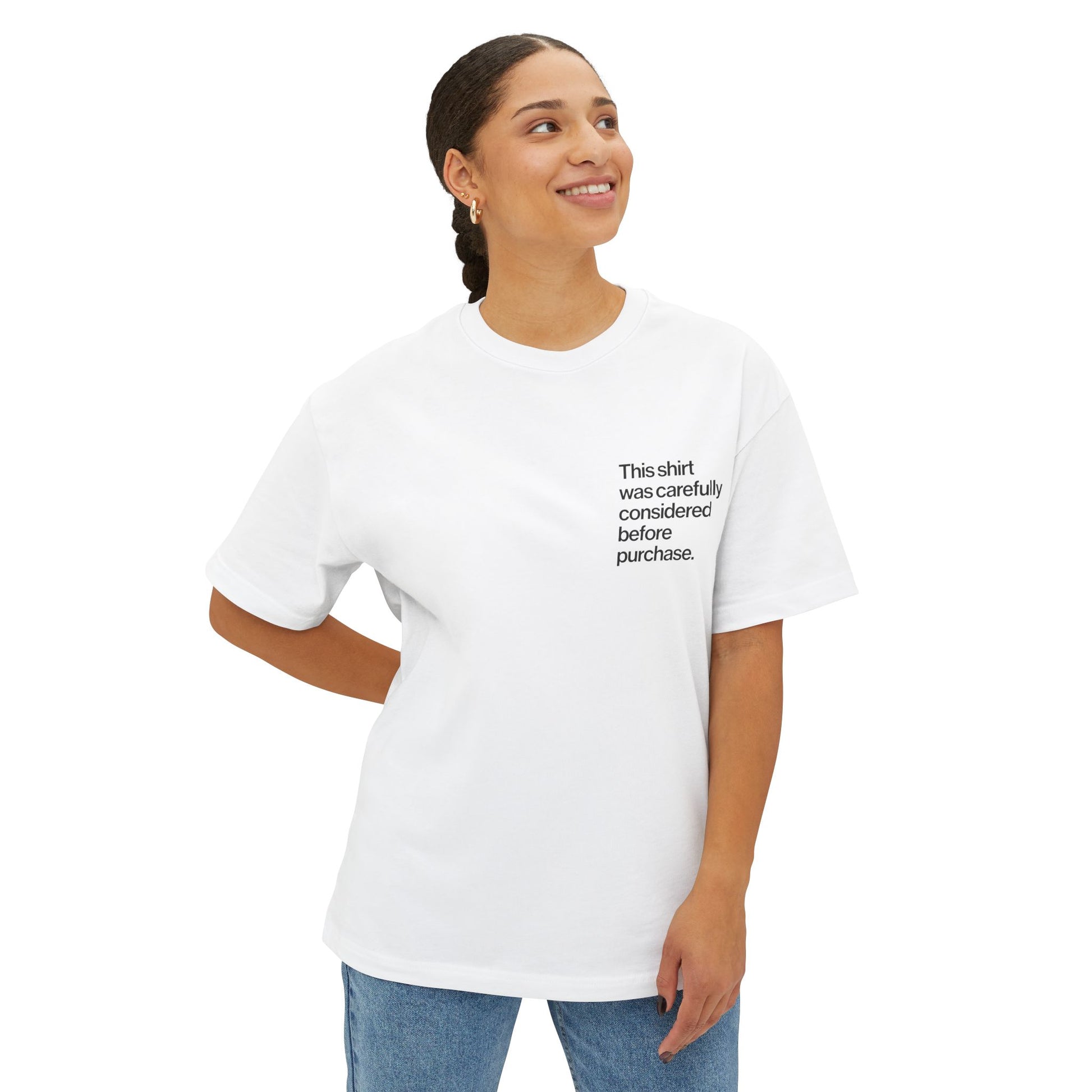 Person wearing a white Introvert T Shirt with minimalist Helvetica left-chest text, subtle design for quiet humor