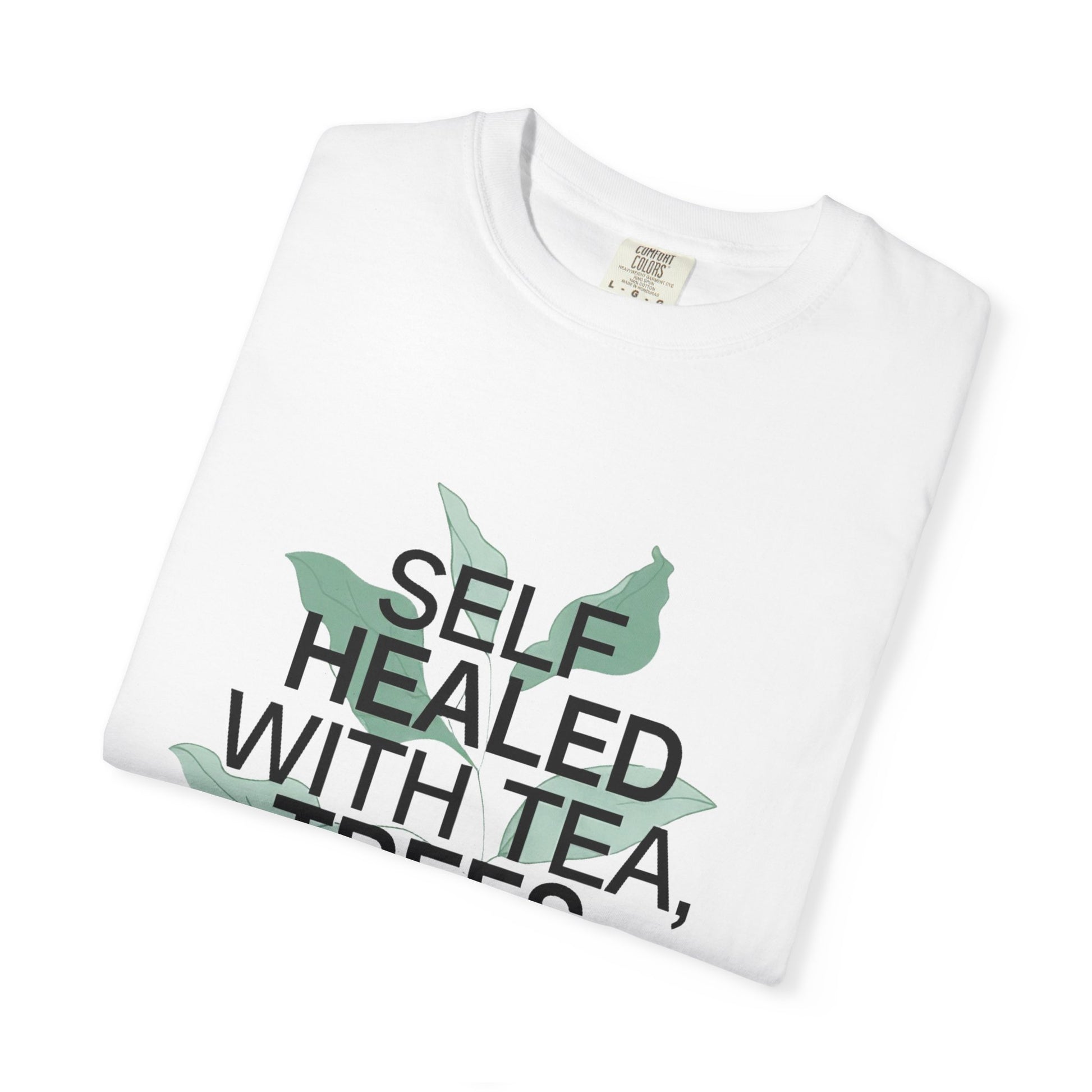 White t-shirt with 'Self Healed with Tea' text and leaf graphics on a white background