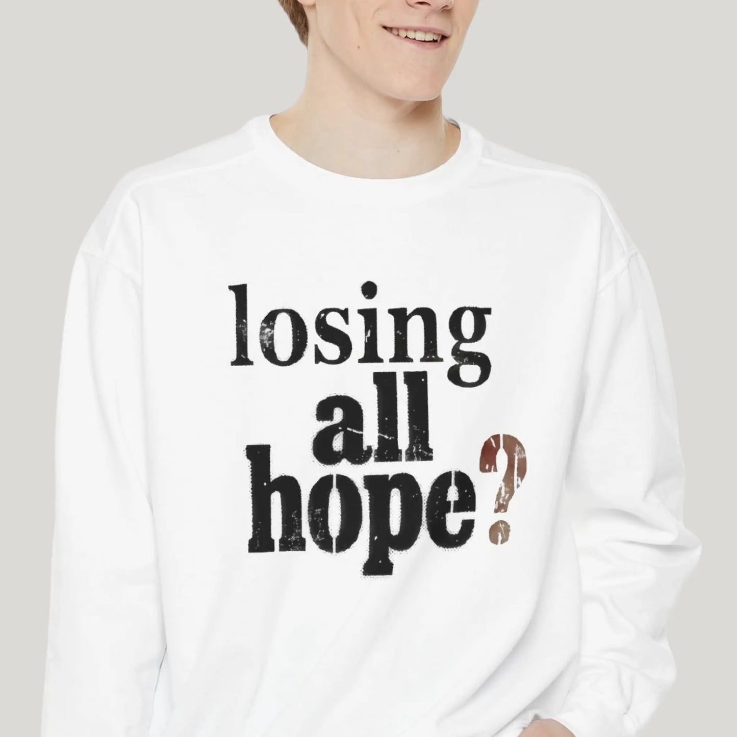 Person wearing a white long-sleeve shirt with 'losing all hope?' text on a plain background