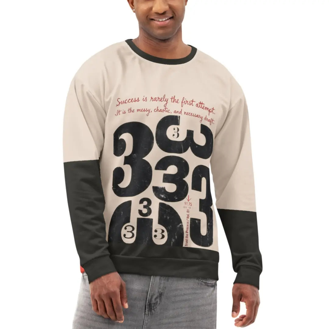 Model wearing a cream crewneck sweatshirt with black sleeves, featuring a distressed “333” typographic graphic and draft-style handwritten text on the front.