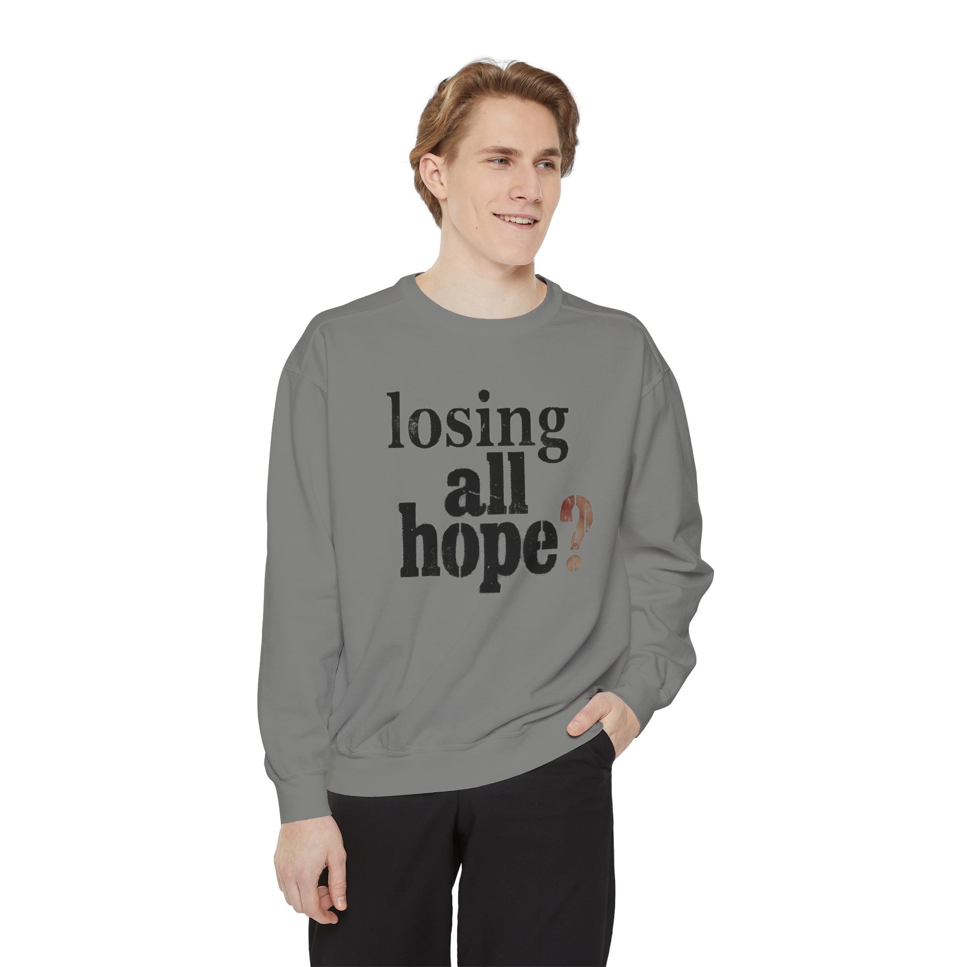 Person wearing a gray sweatshirt with text on a white background
