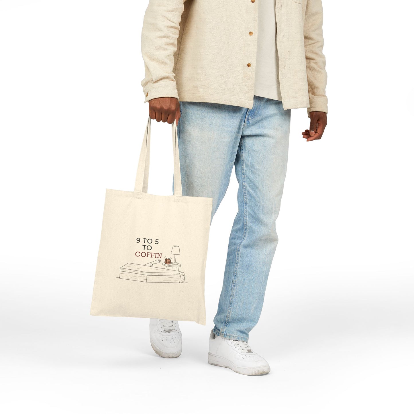 Person holding a Dead Inside tote bag with 9 TO 5 TO COFFIN typography and coffin illustration for burnout humor for introverts