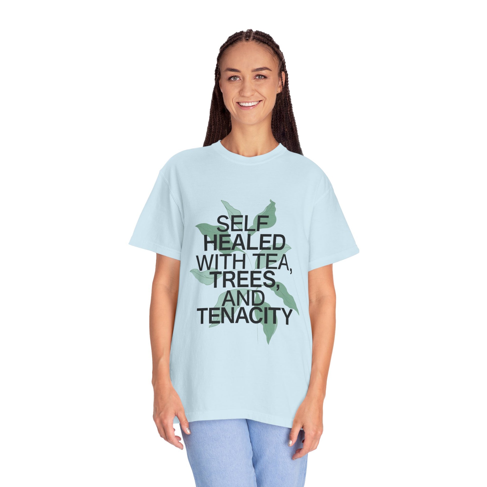 Person wearing a light blue t-shirt with text and a graphic on a white background