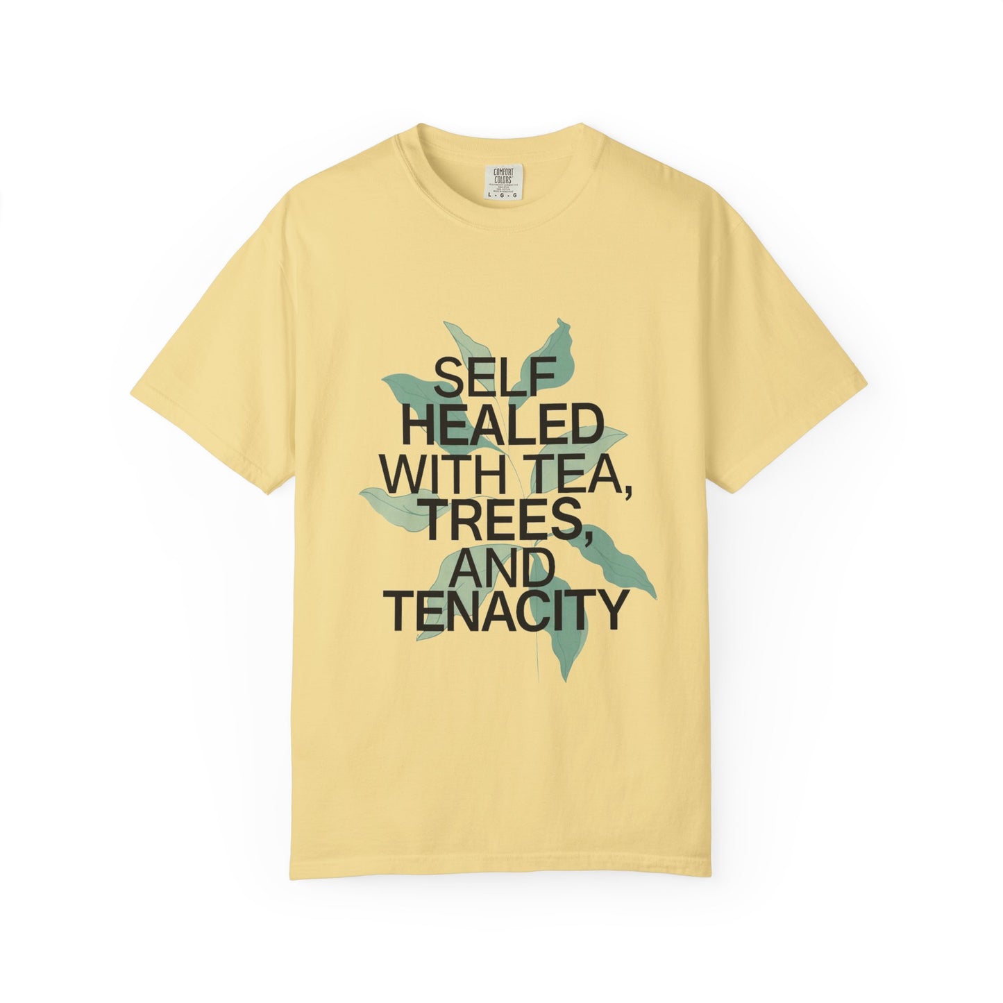 Yellow t-shirt with text 'Self Healed with Tea, Trees, and Tenacity' on a white background