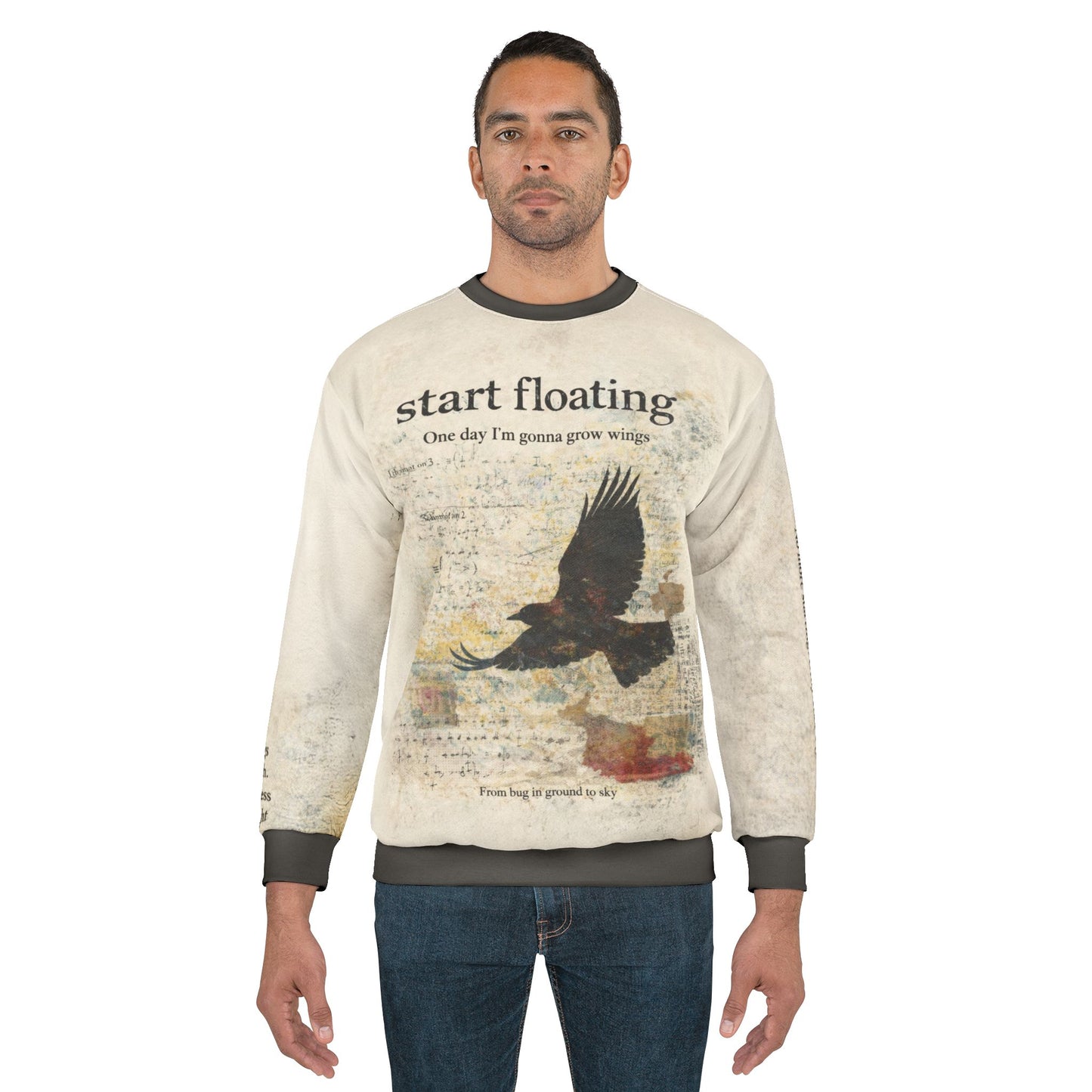Male model wearing a dark academia raven graphic sweatshirt featuring a distressed raven in flight and vintage typography reading “Start floating”