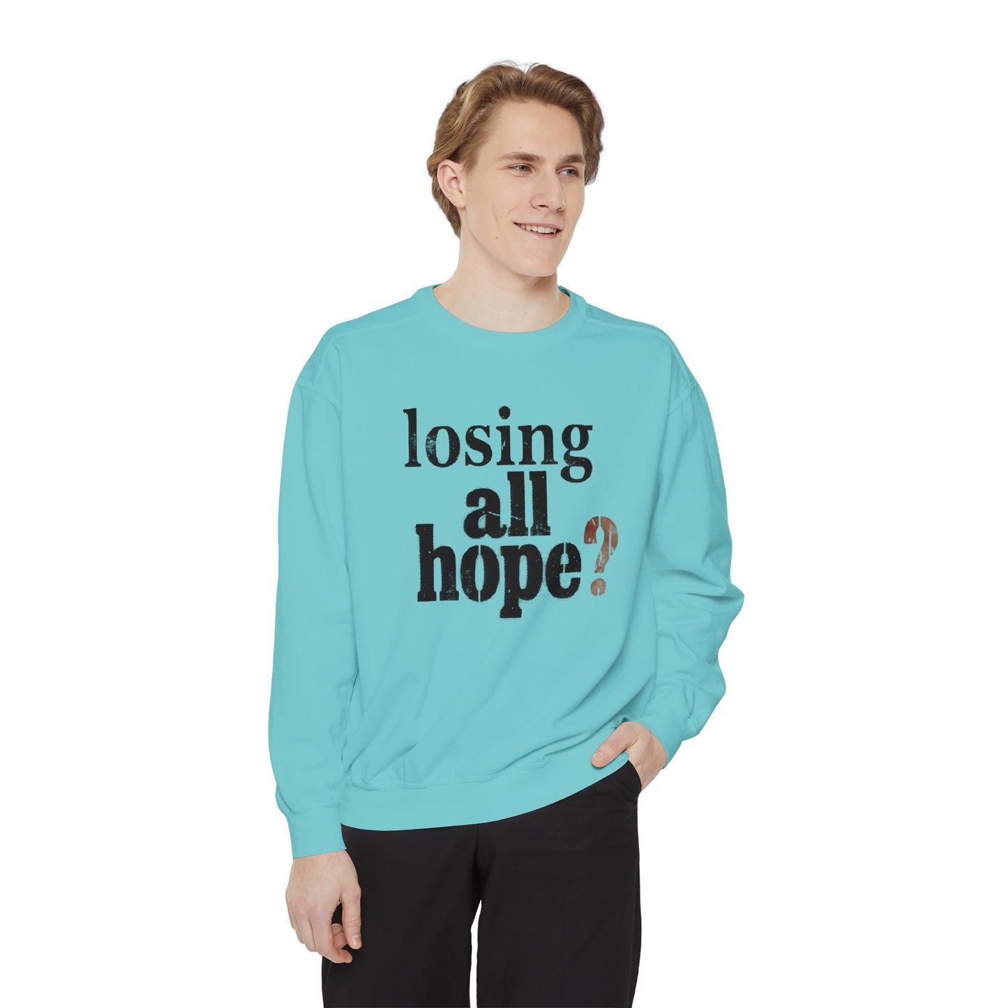 Person wearing a light blue sweatshirt with text on a white background