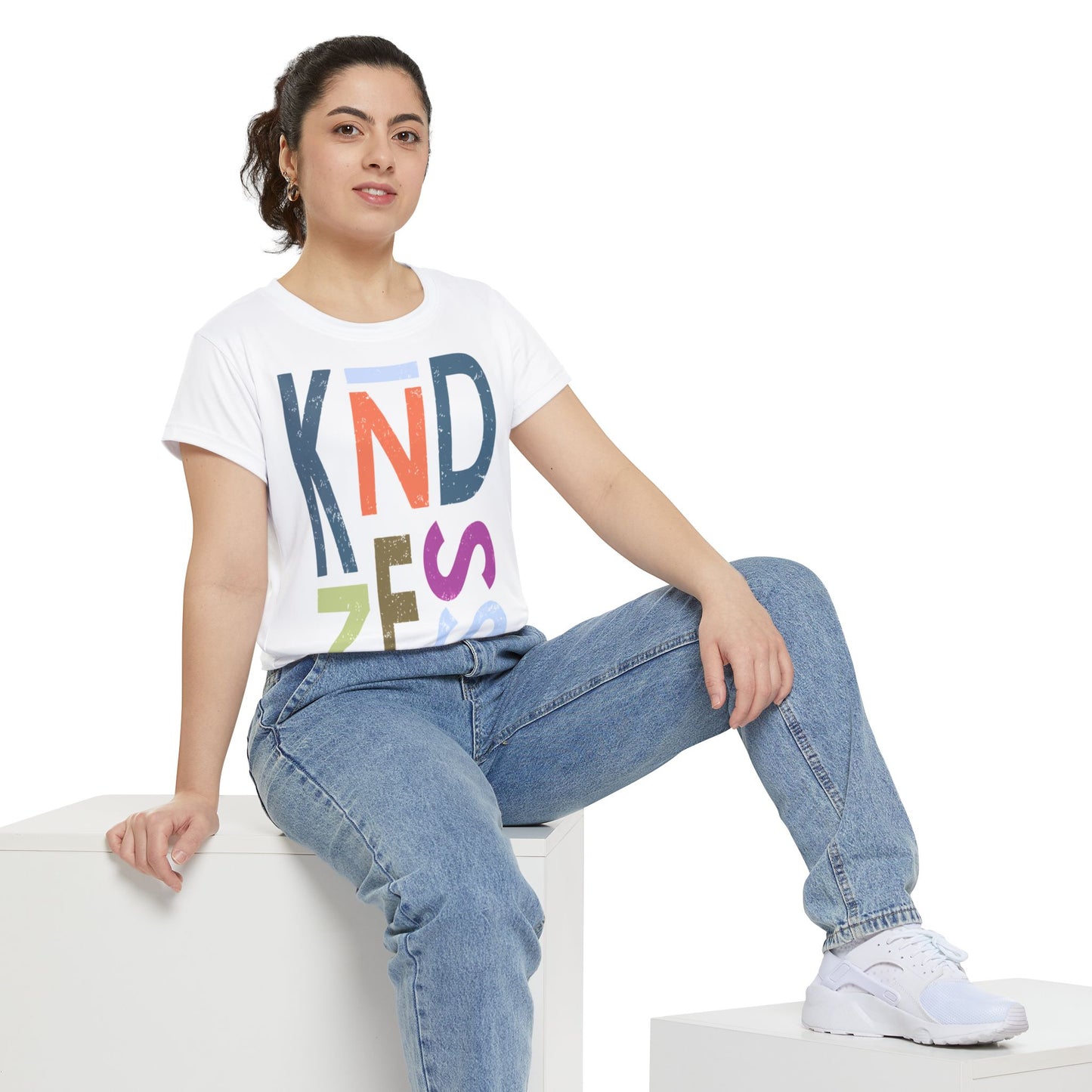 front view women’s white be kind t shirt with large multicolor stacked letters spelling KINDNESS