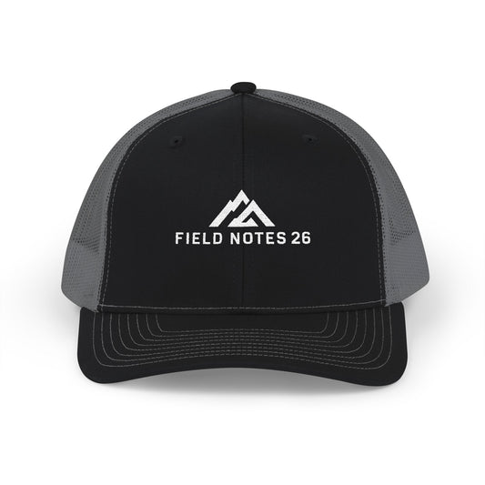 FIELD NOTES 26 Black/Charcoal trucker cap with cream embroidered mountain logo.