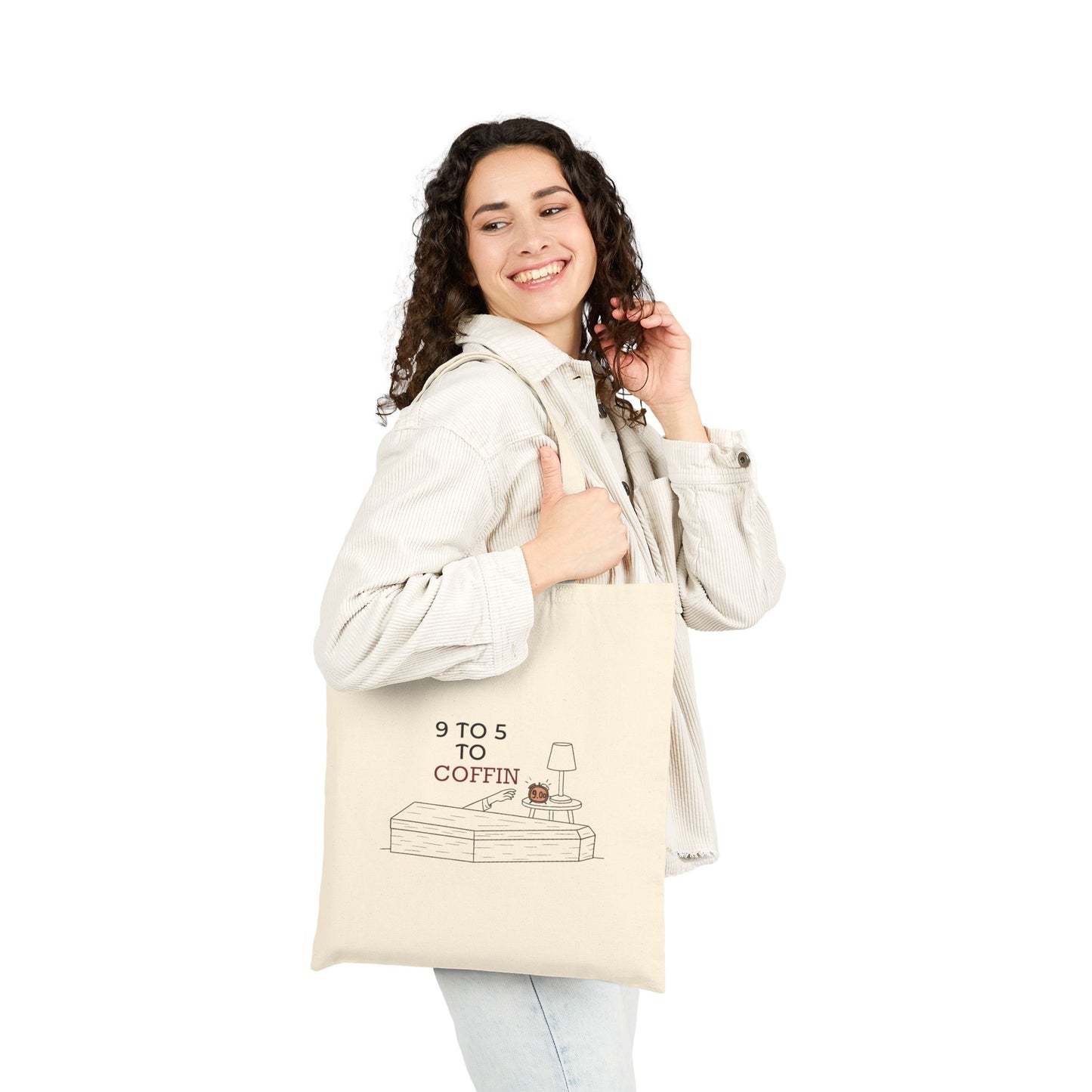 Woman holding a Dead Inside tote bag with 9 TO 5 TO COFFIN typography and coffin illustration for burnout humor for introverts