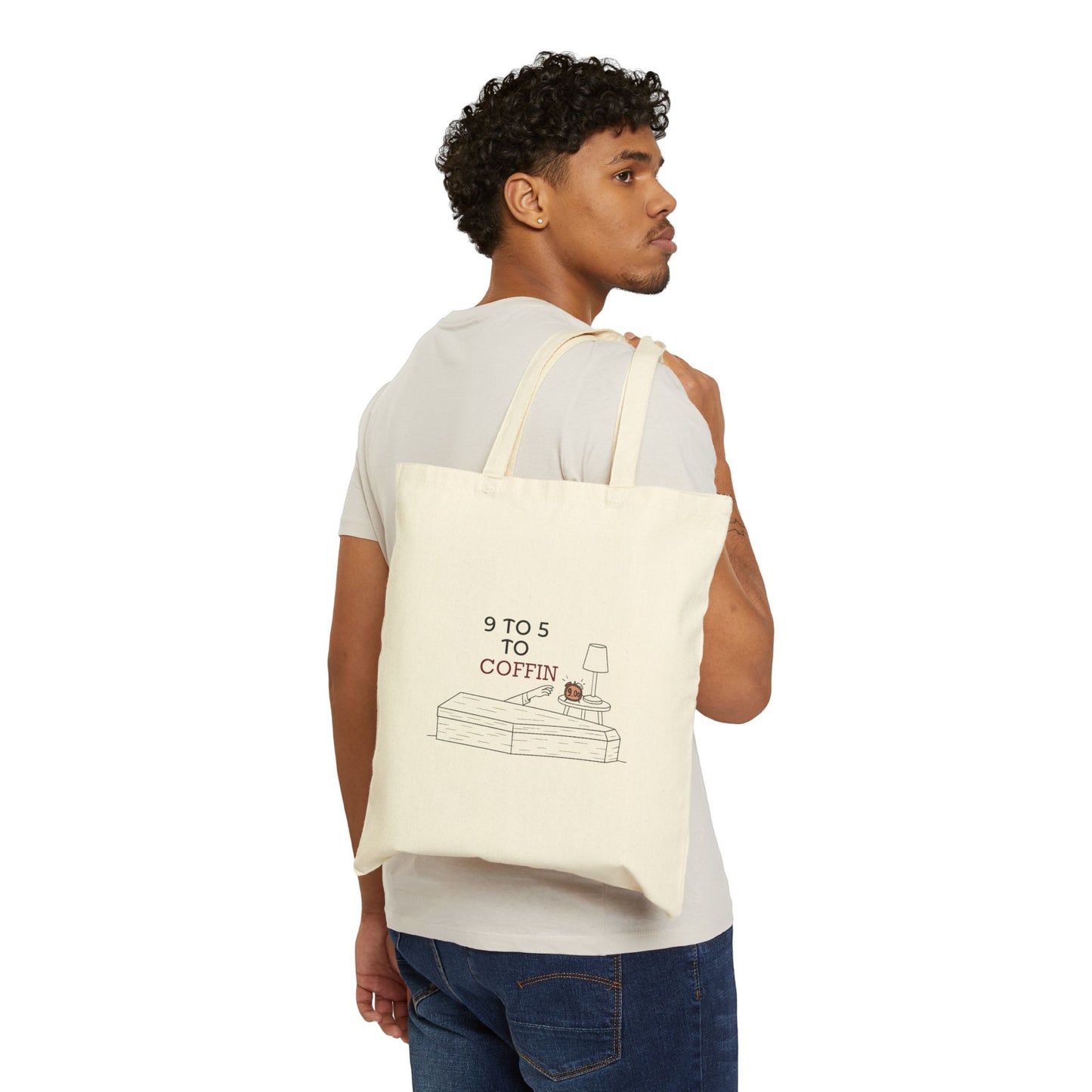 Man carrying a Dead Inside tote bag with 9 TO 5 TO COFFIN typography and coffin illustration for burnout humor for introverts