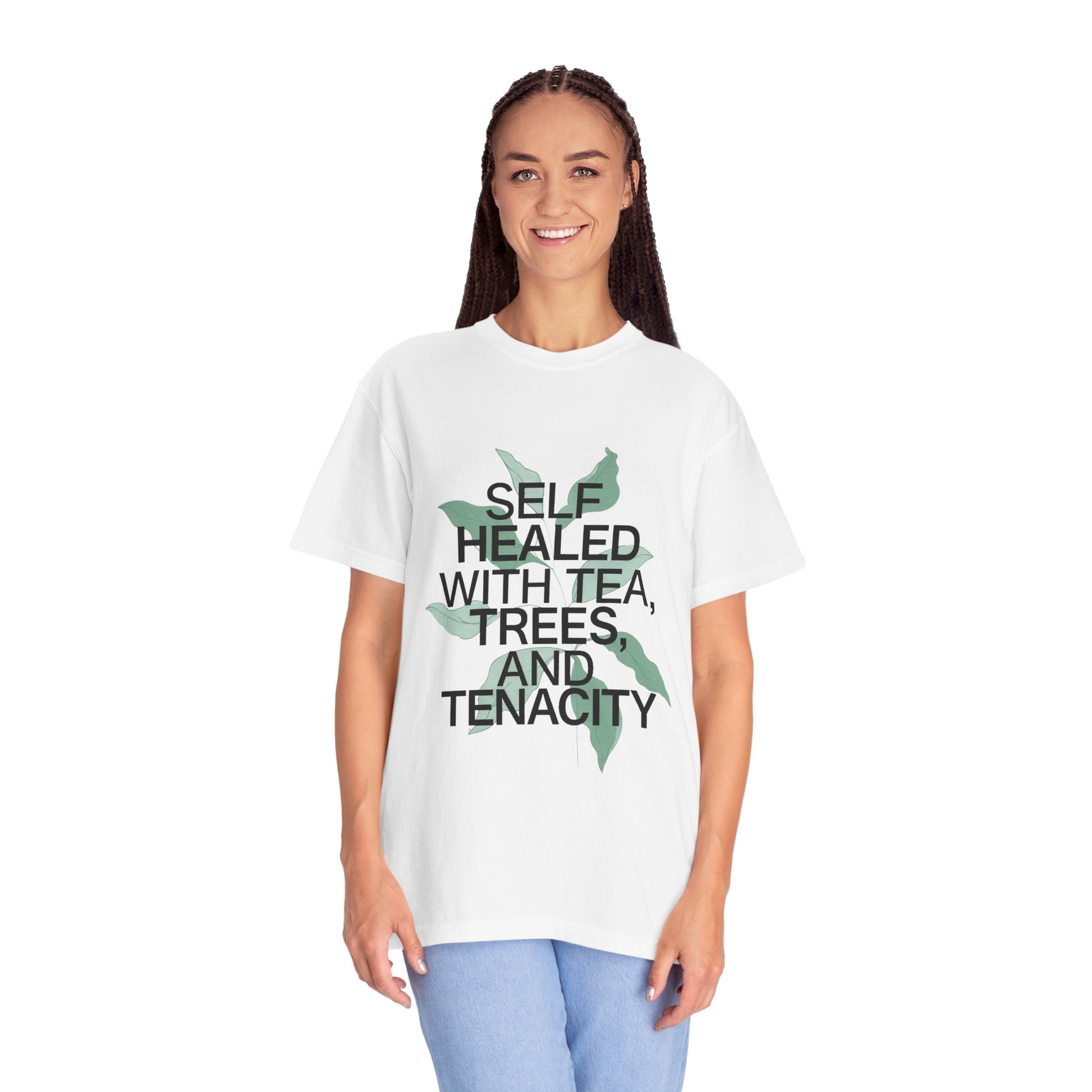 Person wearing a white t-shirt with text and a leaf graphic on a white background