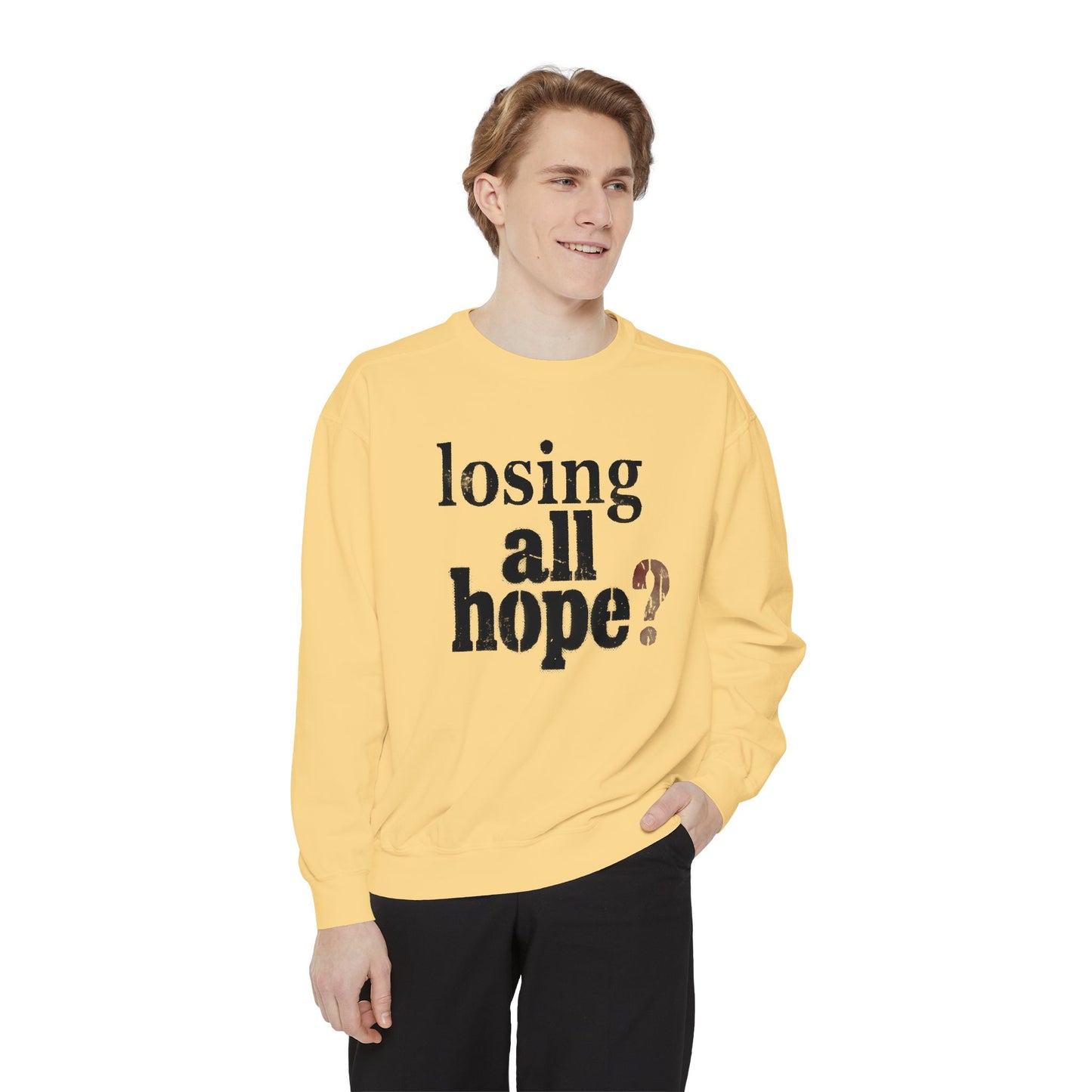 Person wearing a yellow sweatshirt with text on a white background