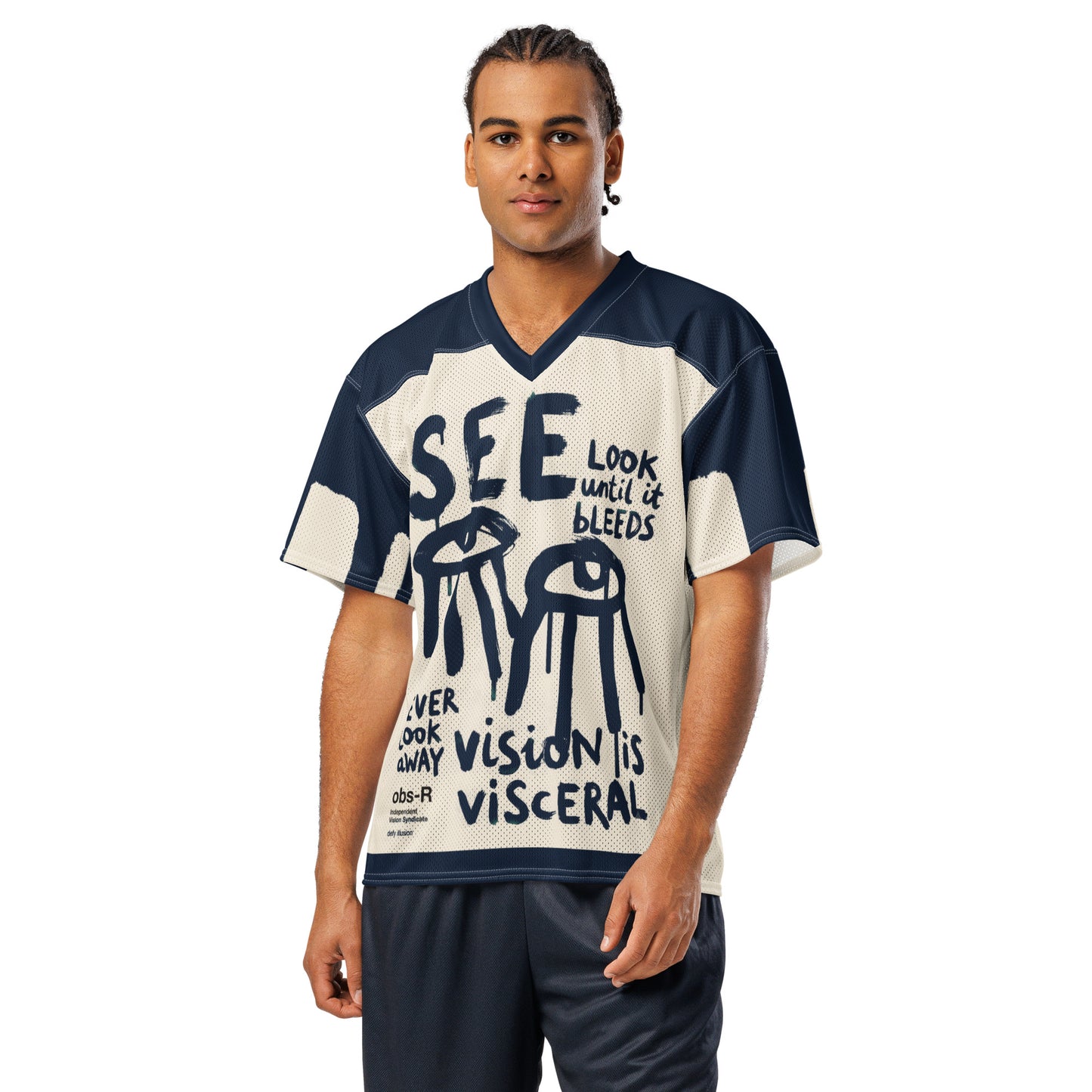 A male model wearing the Gravity of Perception conceptual streetwear jersey. The front displays raw, expressive brush-stroke lettering and dripping eye motifs on a breathable athletic mesh, designed as quiet armor for the thoughtful observer.
