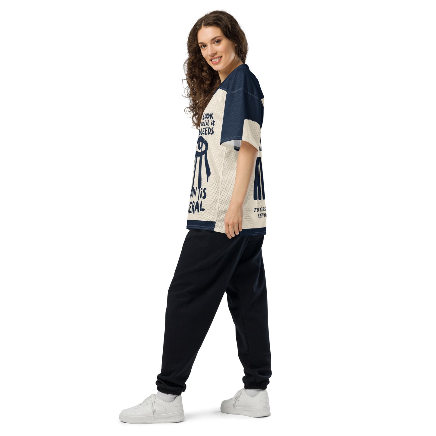 Side profile of the Gravity of Perception all-over-print jersey, showcasing the high-contrast typographic design and relaxed streetwear fit. The breathable athletic mesh and bold navy blue accents on the shoulders are clearly visible from this angle.