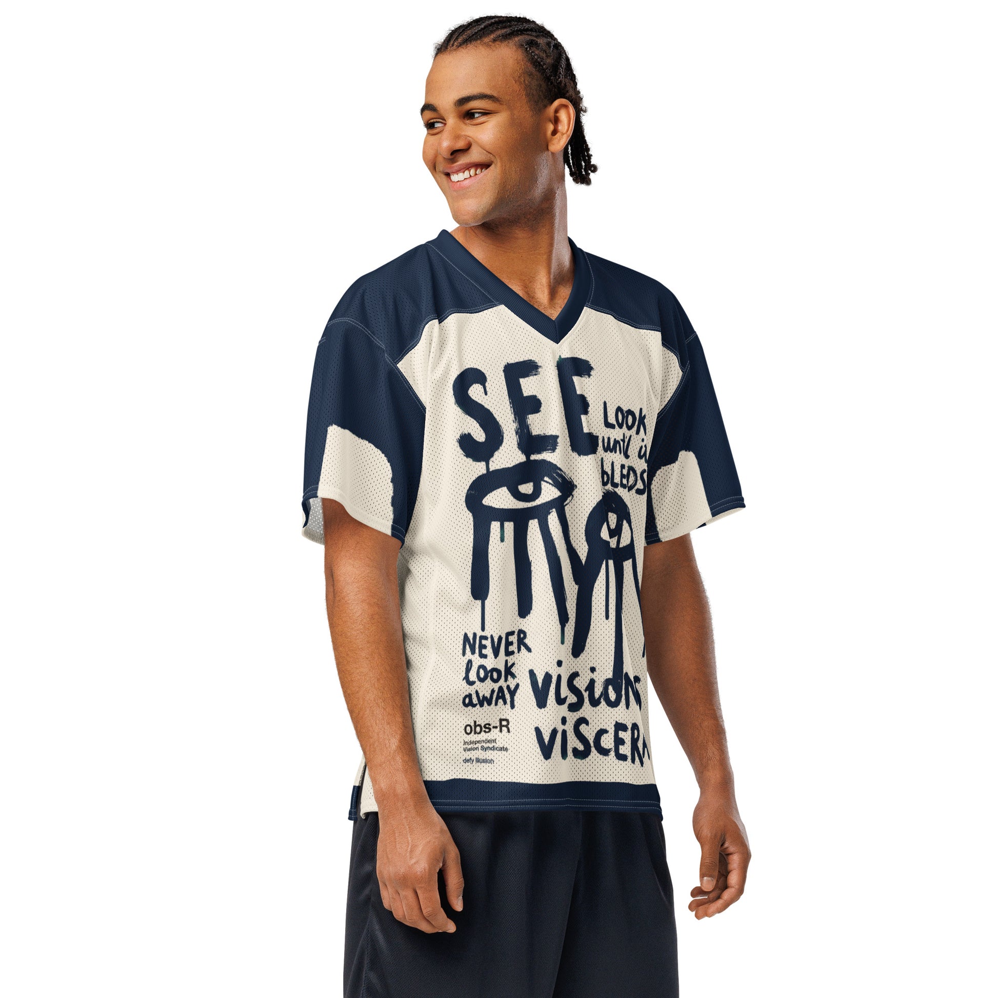 Side profile of a male model wearing the Gravity of Perception all-over-print jersey, showcasing the relaxed streetwear silhouette and high-contrast typographic design. The breathable athletic mesh and bold navy blue sleeve accents are clearly visible from this angle.