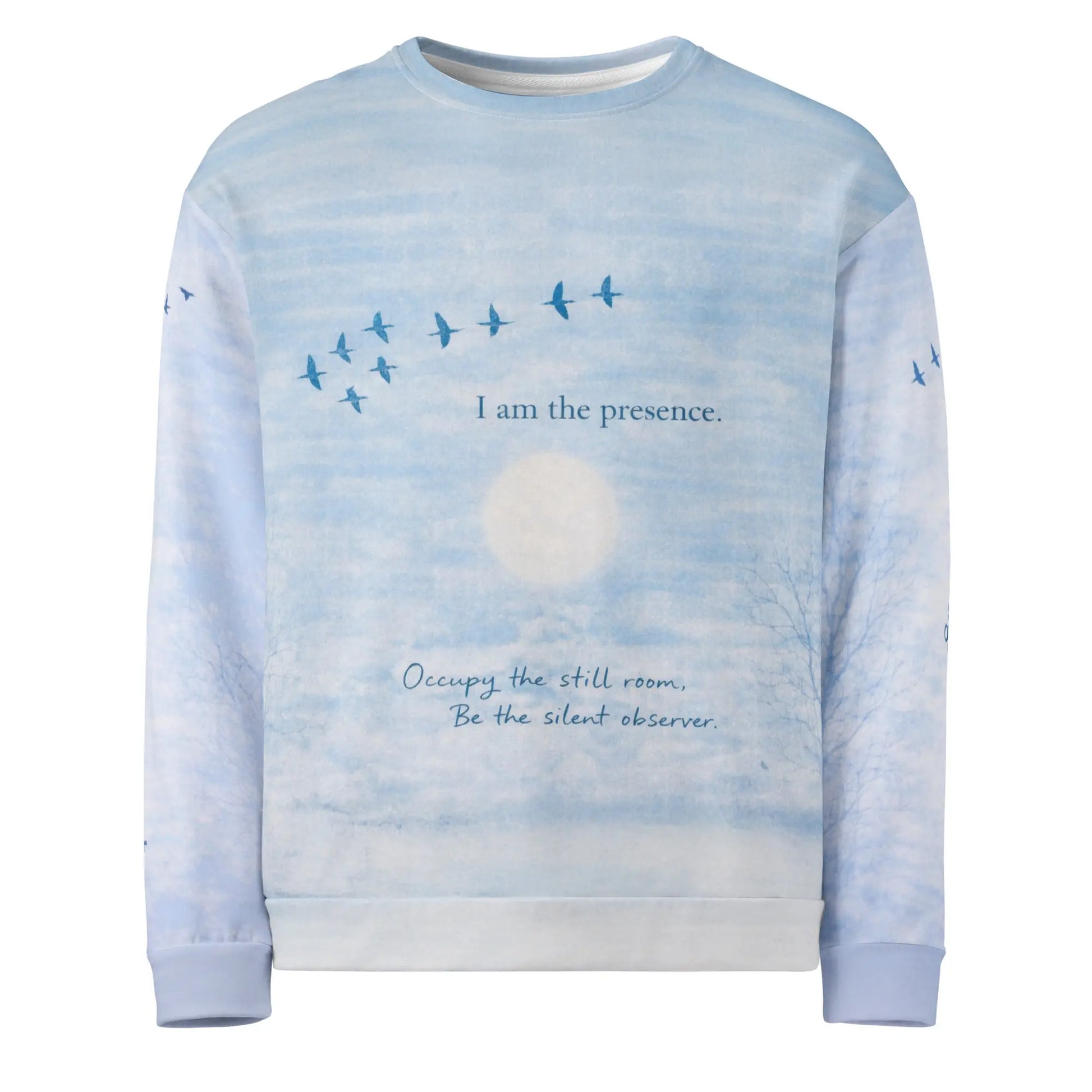 Front view of cloud print quote sweatshirt showing “I am the presence” text with birds in flight and a calm sky background