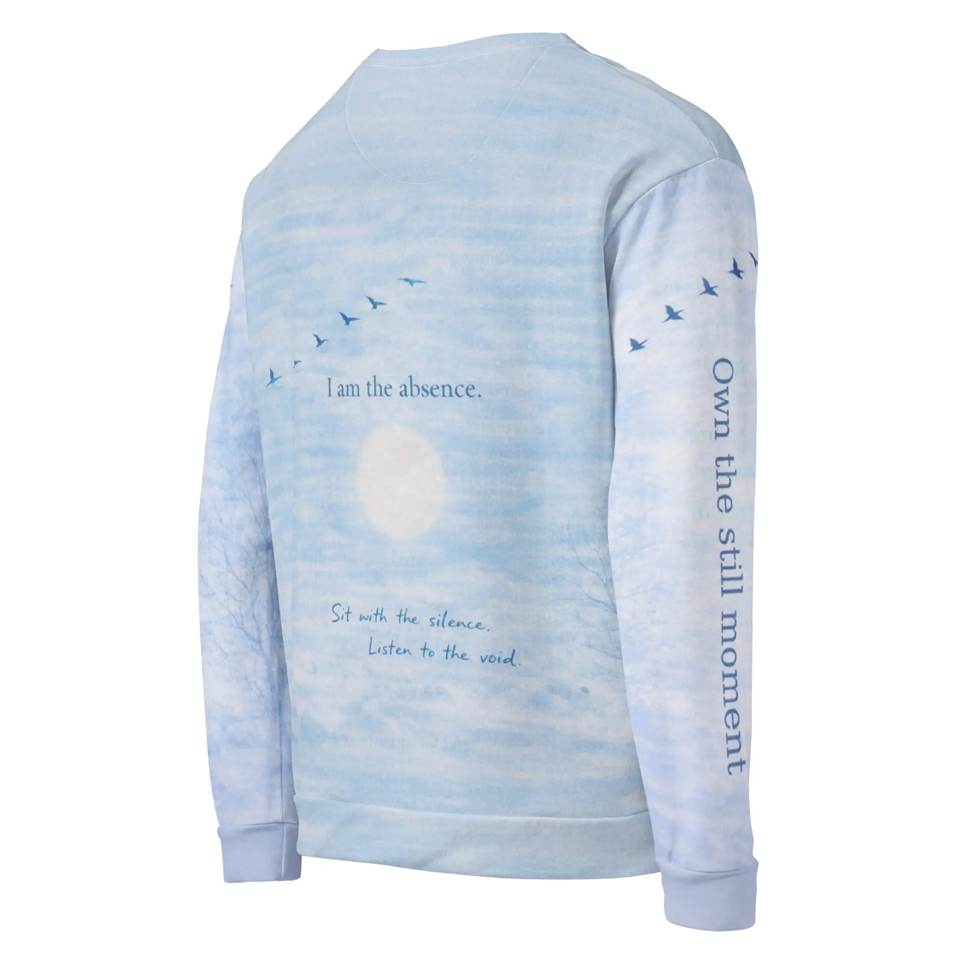 Angled back view of cloud print quote sweatshirt showing “I am the absence” with birds in flight and “Own the still moment” printed on the sleeve