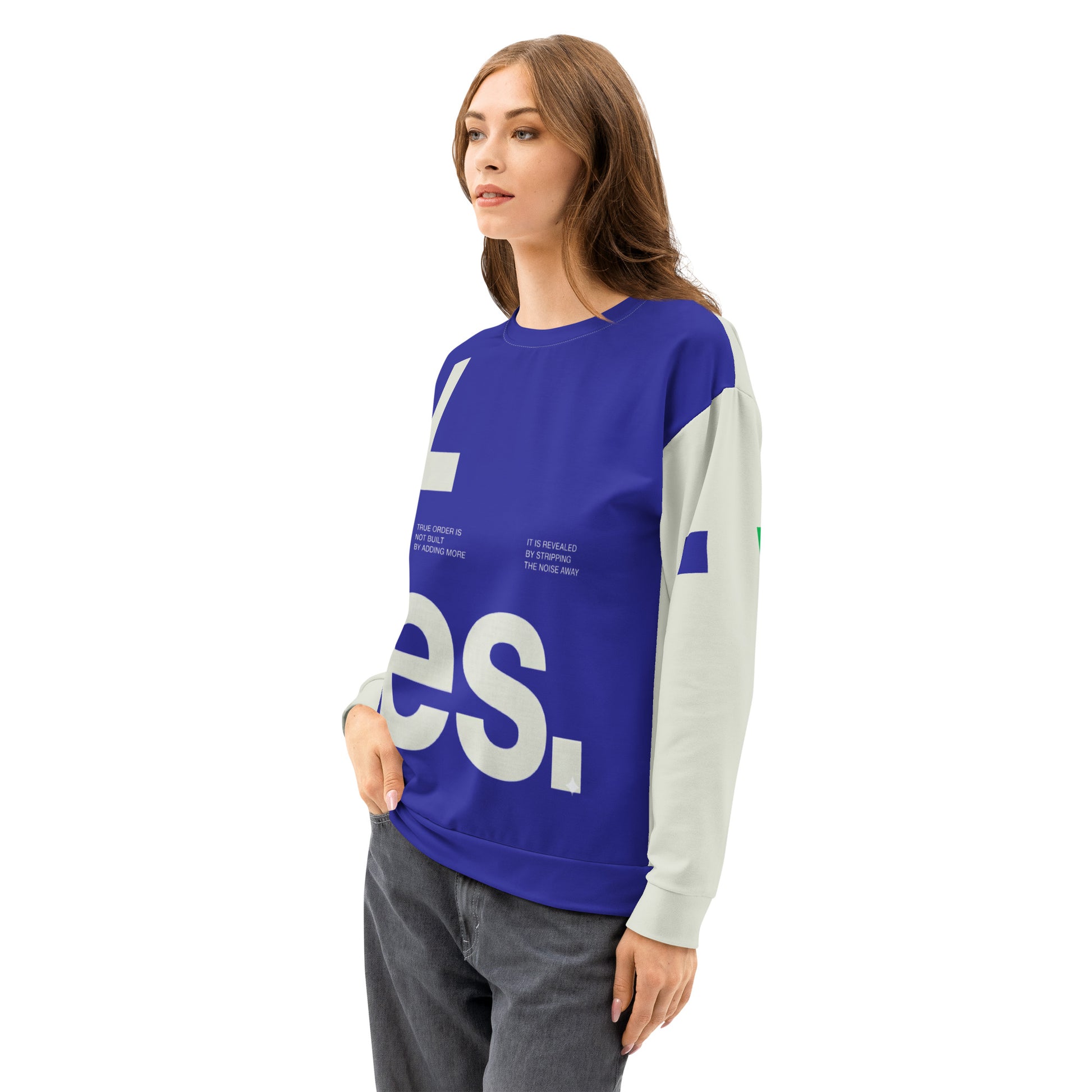 A three-quarter side view of a model wearing the Dialectic Crewneck, showcasing the sharp transition between the deep blue minimalist front panel and the cream-colored sleeve featuring a small, navy geometric square accent.