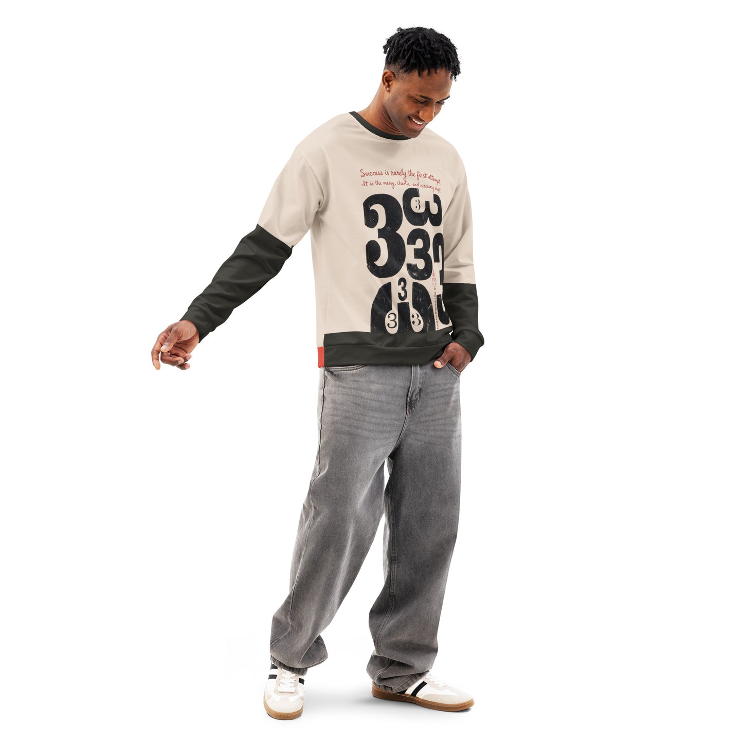 Model wearing a cream crewneck sweatshirt with black sleeves, shown in a relaxed standing pose looking down, featuring distressed “333” draft-style typography on the front in a loose unisex fit.