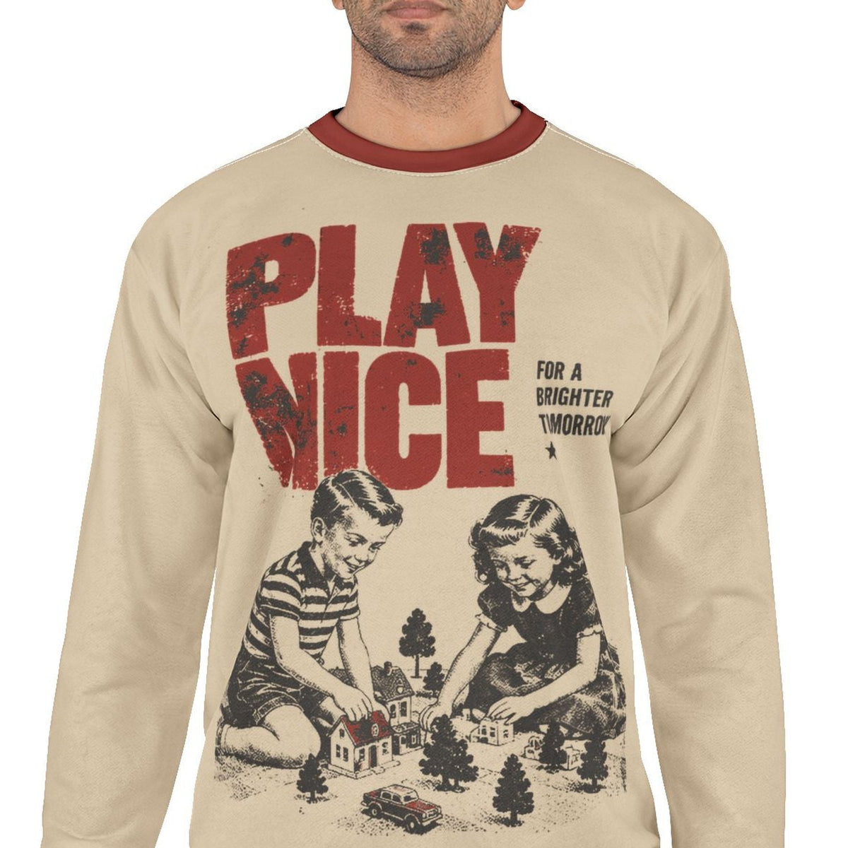 Play Nice retro propaganda sweatshirt worn by a male model, front view with beige body, red trim and vintage graphic
