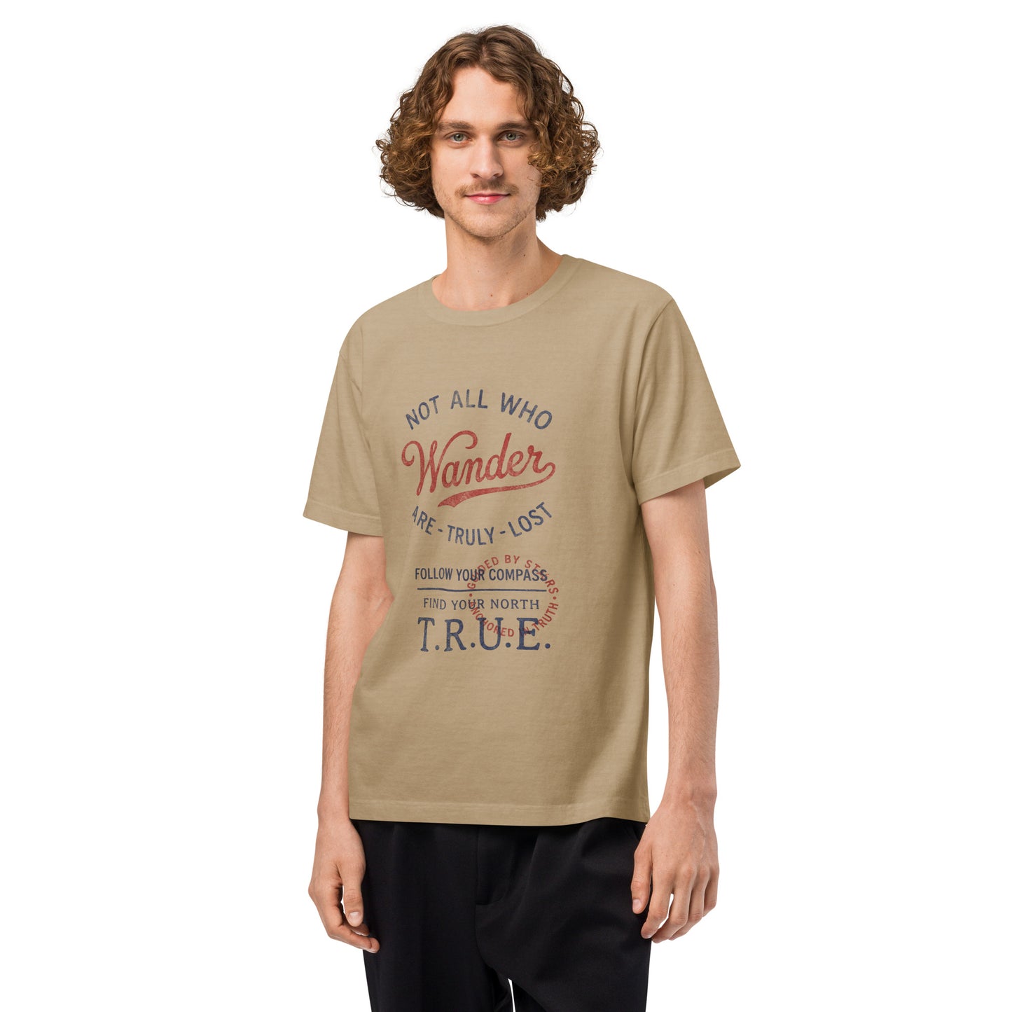 Front view of a model wearing a beige heavyweight streetwear T-shirt with a distressed vintage compass graphic and the text “Not All Who Wander Are Truly Lost,” shown in an oversized unisex, garment-dyed fit.