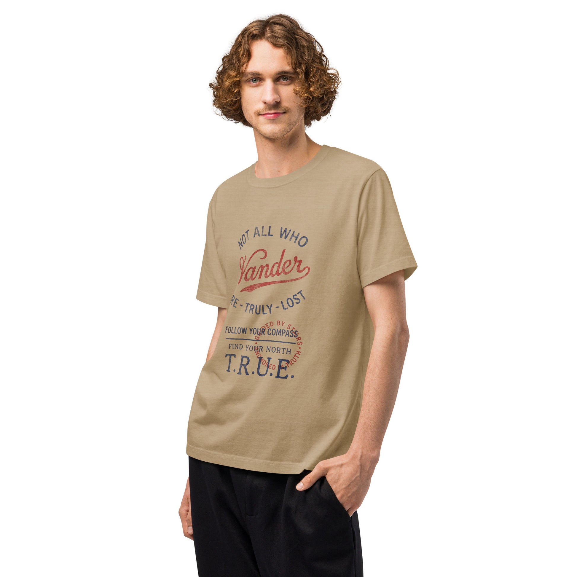 Angled front view of a model wearing a beige heavyweight streetwear T-shirt with a distressed vintage compass “Not All Who Wander Are Truly Lost” graphic, featuring an oversized unisex, garment-dyed fit.