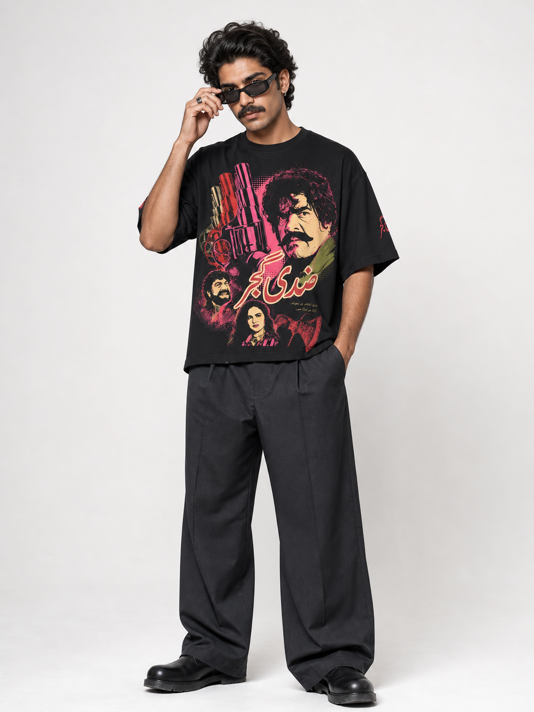 Male model wearing Ziddi Gujjar black oversized tee, front pop-art print