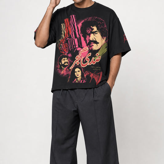 Ziddi Gujjar oversized black T-shirt worn by a male model, front view with Pakistani pop-cinema artwork