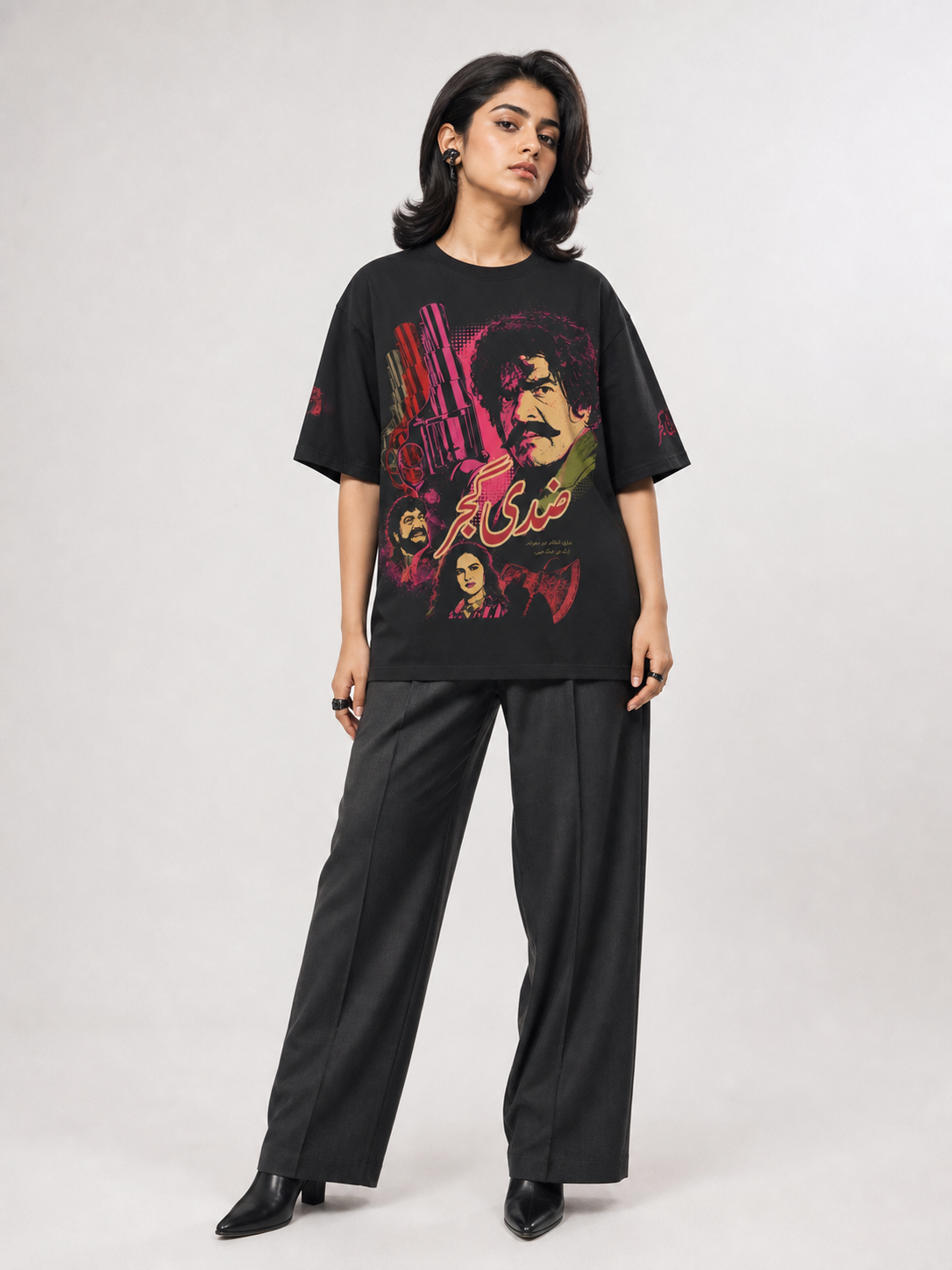 Female model wearing Ziddi Gujjar black oversized tee, front Urdu graphic